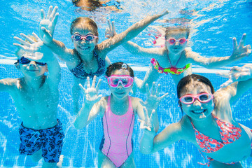 little kids swimming  in pool  underwater. - obrazy, fototapety, plakaty