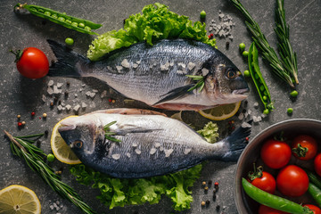 Flat lay of tasty dorado fish with vegetables and spices