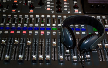 Fototapeta na wymiar The digital studio mixer and headphones