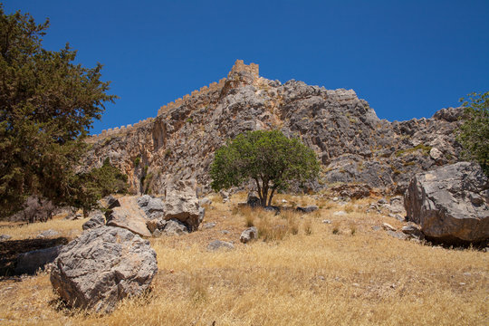 Rock with antique temple acropolis. Acropolis hill in the town of Lindos from the bay side.