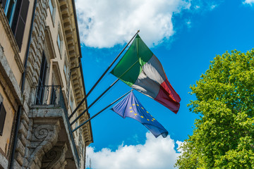italy and europe flag on an italian building - obrazy, fototapety, plakaty