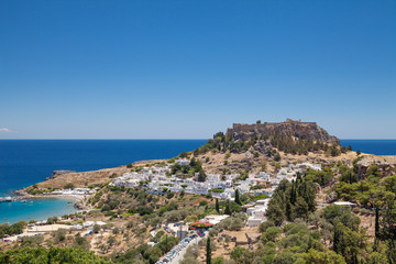 Lindos town at the foot of the mountain. Acropolis of Lindos is located on a hill above the town....