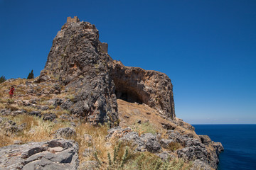 Rock with antique temple acropolis. Acropolis hill in the town of Lindos from the bay side.