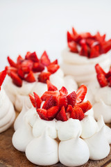 Pavlova meringue cake decorated with fresh strawberries