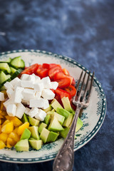 Delicious tomato, bell pepper, cucumber, avocado, onion and feta salad