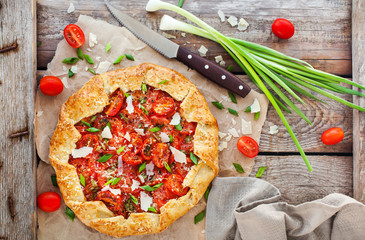 Delicious homemade rustic open pie (galette) with tomato, cheese and onion