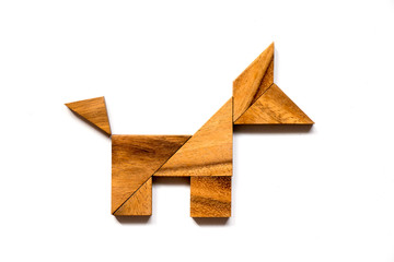 Wooden tangram puzzle in dog shape on white background