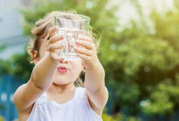 Child drinks water. 