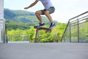 young woman skateboarder skateboarding at city