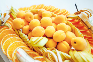 Fruit on a tray. Bananas apricots apples and pears