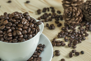 close up coffee beans in cup with  wooden background, selective focus and effect filter.