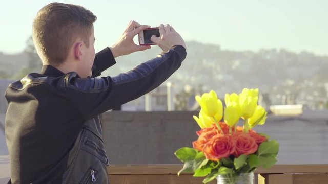 Fashionable Man Takes A Photo Of The View From A Rooftop 