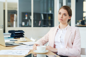 Pensive manager with cup of tea having break