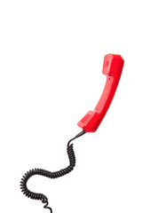 Close-up view of red telephone handset with curly cord isolated on white