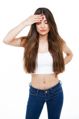 Beautiful young woman having headache over white background.