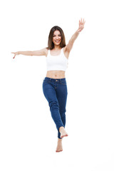 Obraz premium Beautiful young woman dancing over white background.