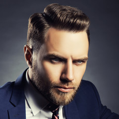 Close-up portrait of handsome man with beard and stilish hair cut