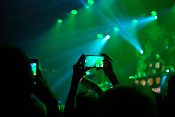 Modern gadget held by human recording pop concert