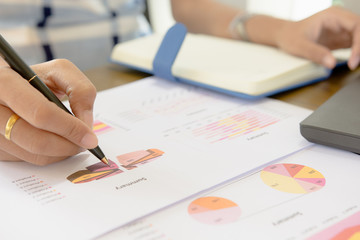 Businessman check seriously analyzes a financial reports. Financial reports are set of documents...