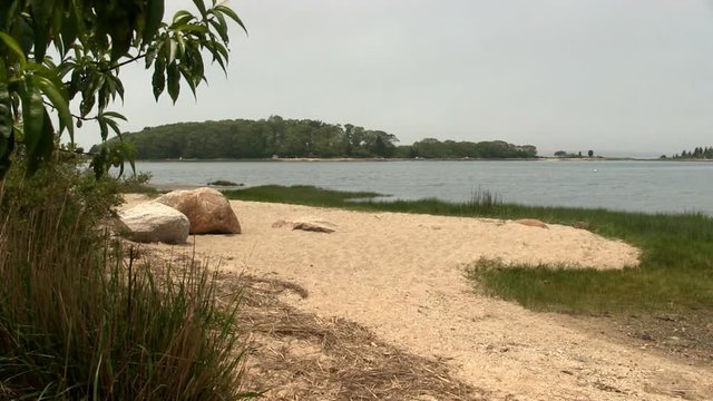 View of Toby's island from sandy beach shoreline at Bennets Neck Pocasset Bourne Cape Cod