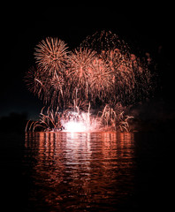 Spectacular rouge fireworks over lake	