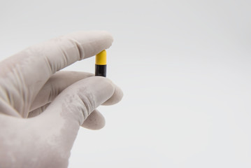 Colorful  capsules drug  in hand on white background.