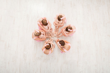 Little girls dancing ballet in studio, top view