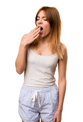 Beautiful girl in pajamas yawning