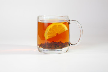 Black tea with lemon in a glass cup.