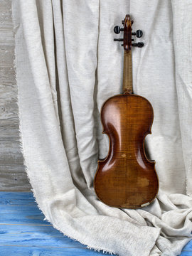 Ancient violin on a wooden board. 
