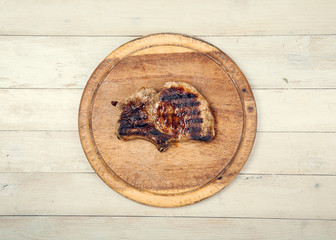 Grilled meat on wooden board