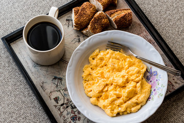 Naklejka premium Turkish Breakfast with scrambled egg, simit (bagel) and tea or coffee.