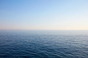 Tuinposter Mediterranean blue, calm sea and horizon, clear sky in Italy © andersphoto