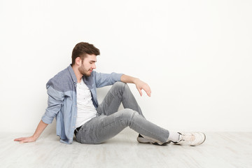 Relaxed man sitting on floor