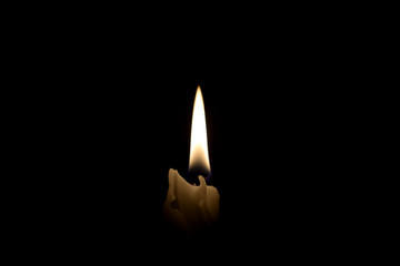 Candle on the black background isolated