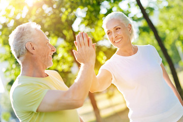 Contented aged couple resting in the park