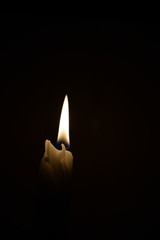 Candle on the black background 