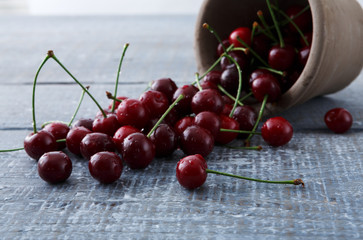 Fresh cherries closeup on blue rustic wood
