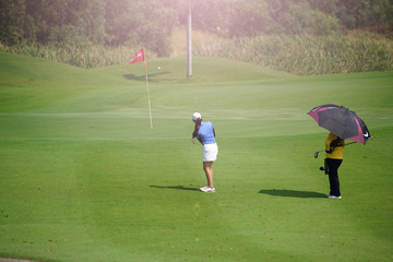 Woman golf is a sport requiring heat tolerance.