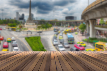 wooden floor for your text or object and blurred victory monument in Thailand in the background.