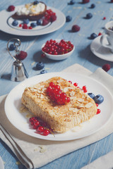 Pastry pie, tea, coffee and berries at blue rustic wood