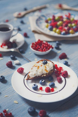 Breakfast with baked pea and berries at blue rustic wood
