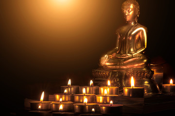 Selective focus of buddha statue with blurred burning candle light in soft night light. Concept of peace, meditation, hope and relaxation