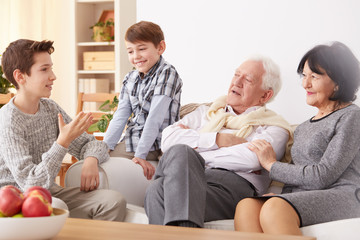 Obraz na płótnie Canvas Grandsons spending time with grandparents