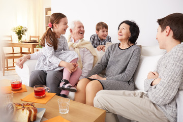 Grandchildren laughing with grandparents