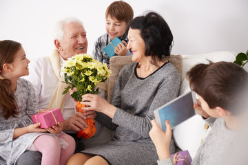 Grandparents receiving flowers and presents