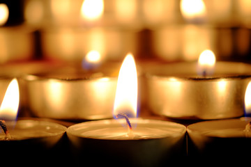 Selective focus and close Up Group of burning candles in thai style  and concept of peace, meditation and relaxation