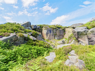 At the top of a hillside near Surprise View in Derbyshire is an overgrown long abandoned millstone quarry.