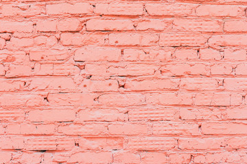 Old painted red brick wall, natural rough gritty texture to the background. For natural design, patterns, background with space for copying text.