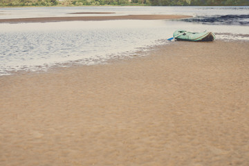 Fototapeta na wymiar Single rubber boat on the beach